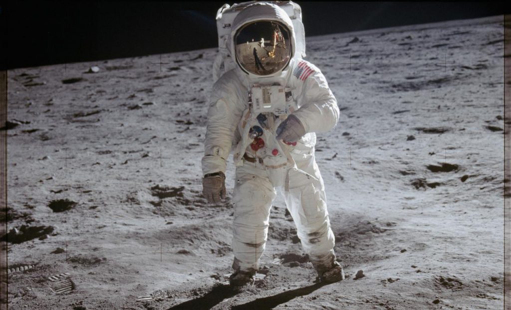 Astronaut Edwin Aldrin walks on lunar surface near leg of Lunar Module